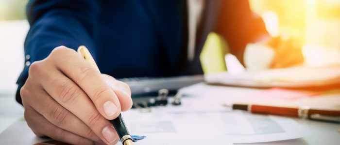 Stock photo of a businessperson looking over number charts.